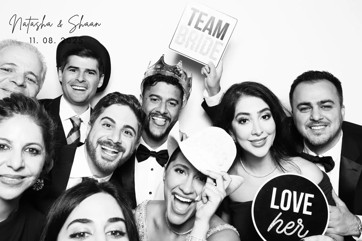 Guests posing at Clutch City glam photo booth at Houston wedding reception